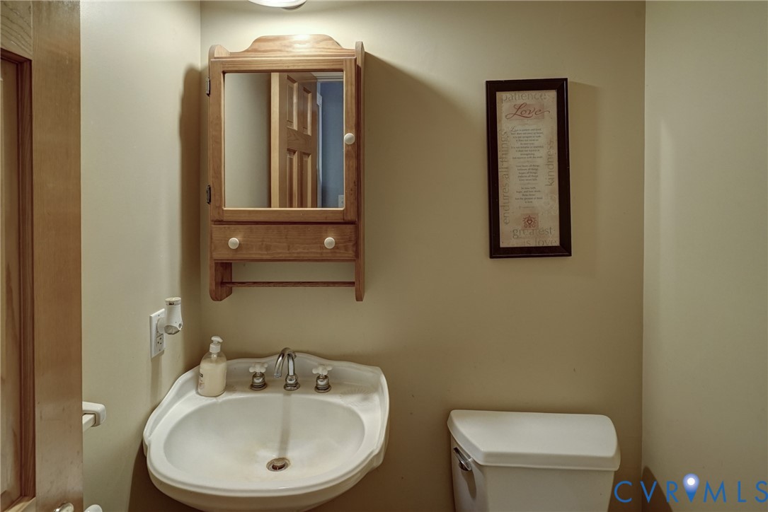 Half Bath off Foyer; Hardwood Floors, Pedestal Sink