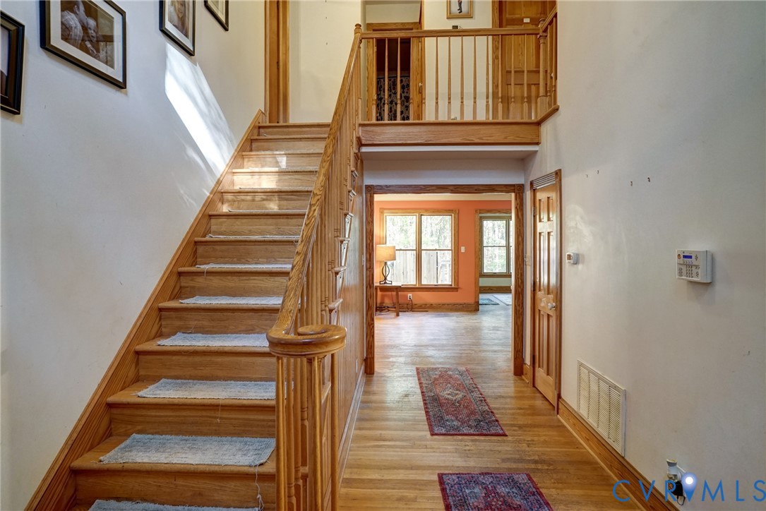 Large Vaulted Foyer, Hardwood Floors, Custom Trim, Solid Wood Doors