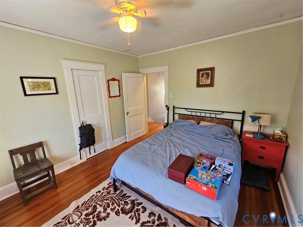 Hardwood flooring, multi-panel interior doors with original-style woodwork trim, and a ceiling-mounted light fixture