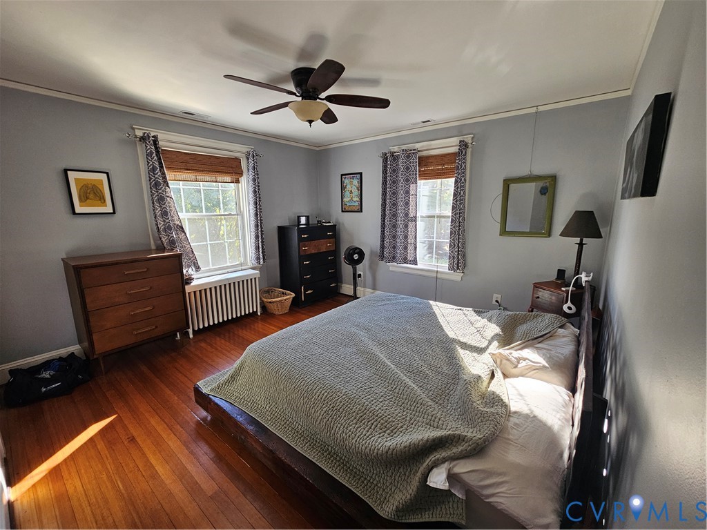 Hardwood flooring, double-hung windows, and ceiling fan fixture