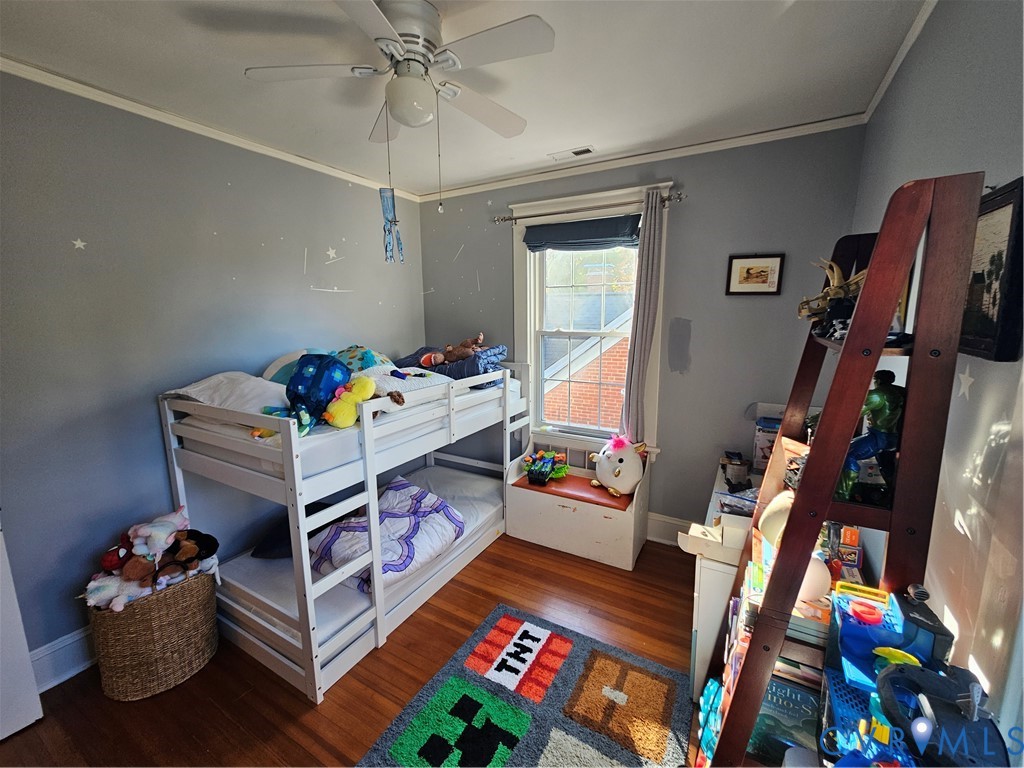 Hardwood flooring, ceiling fan with integrated light fixture, and built-in window seat