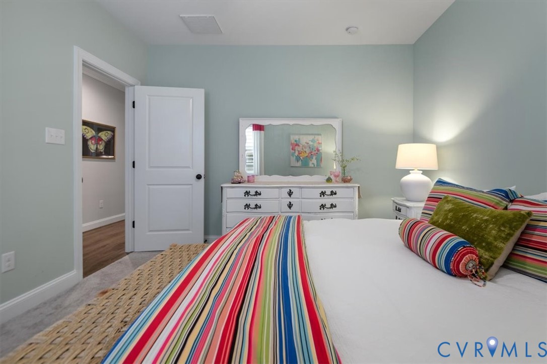 Terrace Level - Bedroom featuring neutral-toned walls, carpeting, and a two-panel interior door with matte black hardware