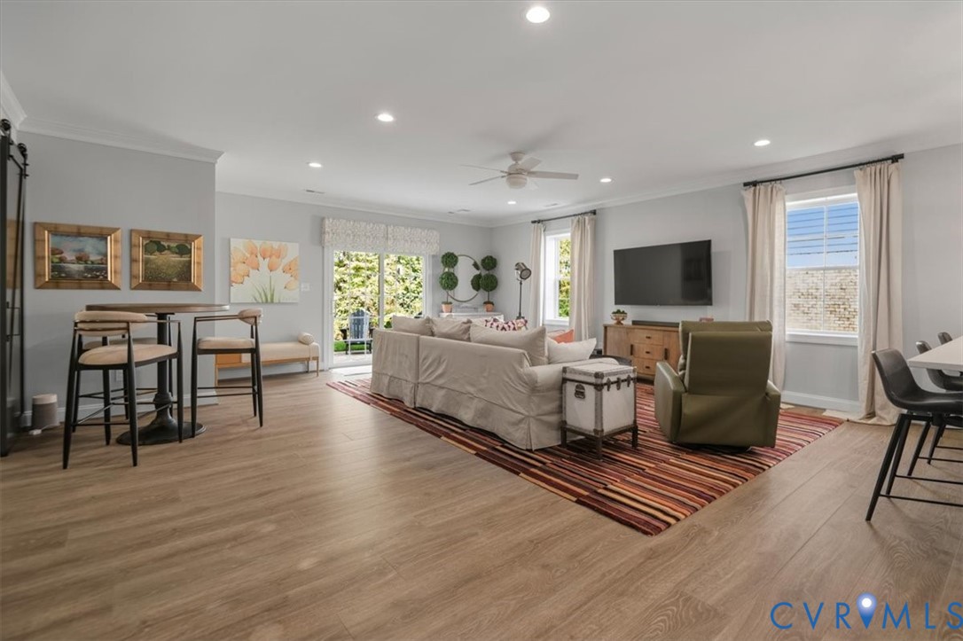 Terrace Level -Open-concept living space featuring wood-finish flooring, recessed lighting, a ceiling fan, and sliding glass doors