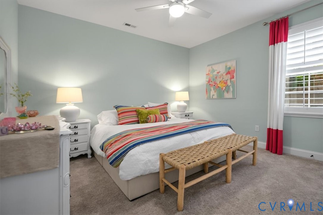 Terrace Level - Neutral-toned carpeting, ceiling fan with integrated lighting, and plantation-style window shutters