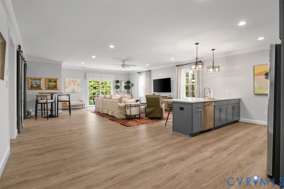 Terrace Level - Open-concept kitchen featuring an oversized island with gray cabinetry, recessed lighting, wood-finish flooring, and sliding glass patio doors