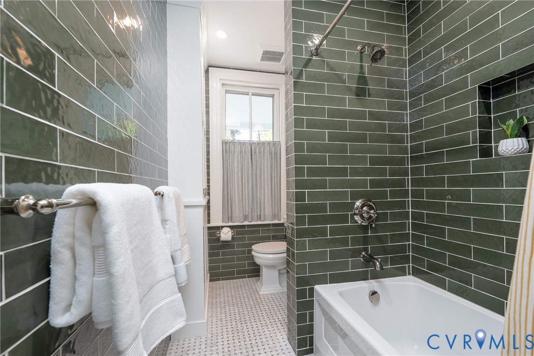 Full bath redone in 2025 by Anne Pulliam Interiors, with designer tile and a heated marble floor.
