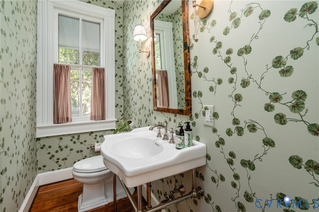 Powder room redone in 2025 by Anne Pulliam Interiors, with botanical wallpaper and a console sink.