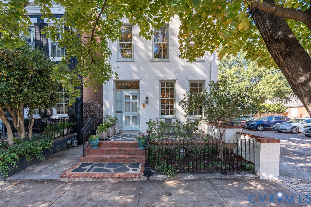 Transom over the front door, brick steps and an iron fence along the sidewalk. Transom over the front door, brick steps and an iron fence along the sidewalk.