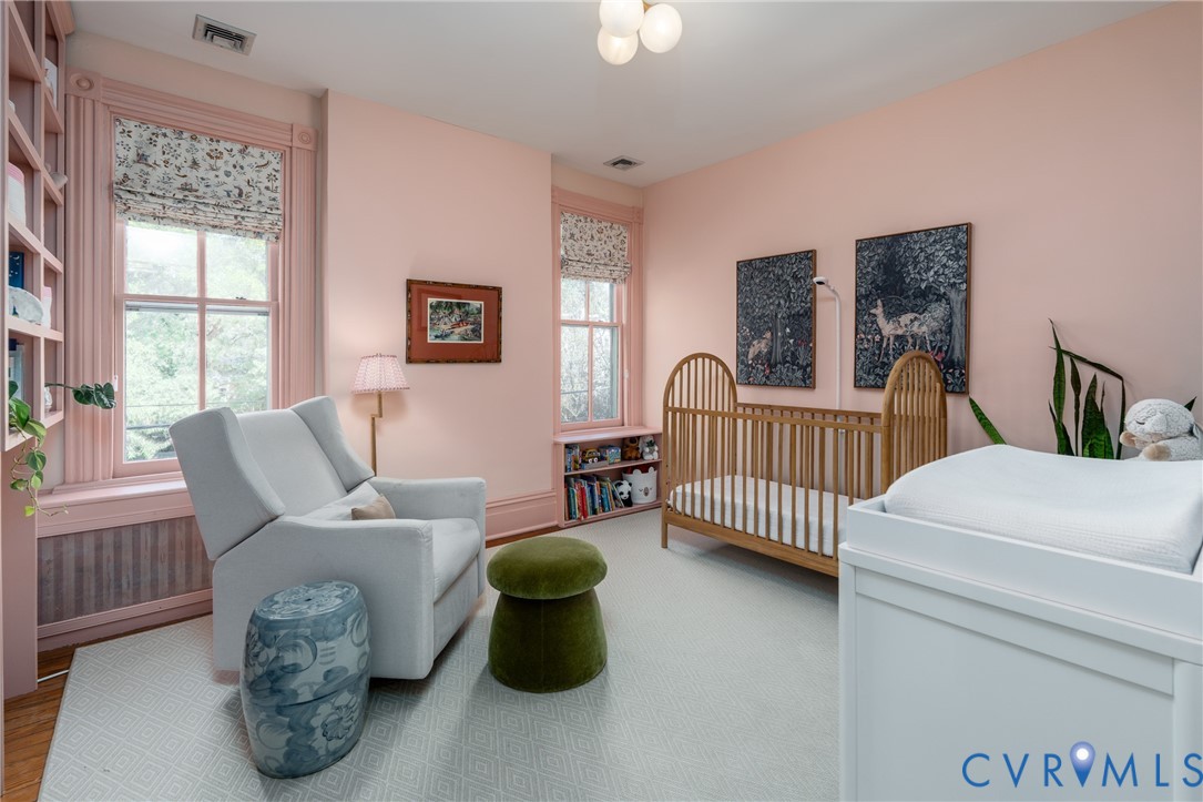 Second bedroom with 2 windows and built-in shelving.