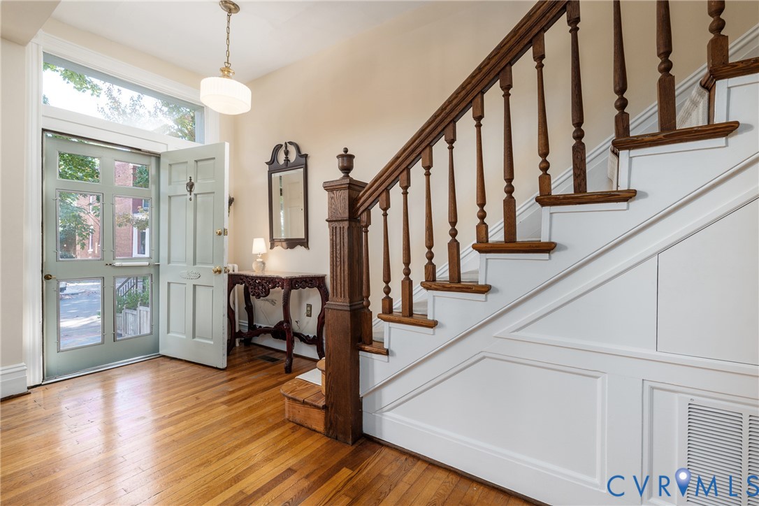 Foyer with a transom over the front door and the original staircase. Foyer with a transom over the front door and the original staircase.