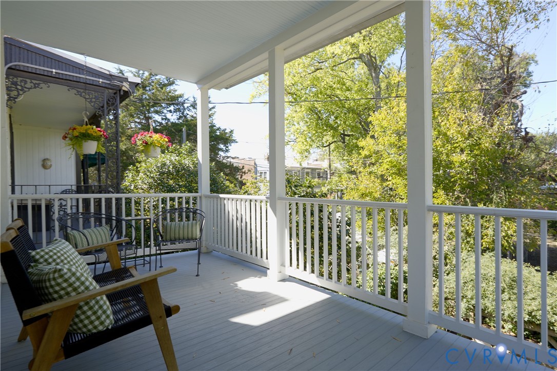 Covered porch off the third bedroom, overlooking the garden and treetops.