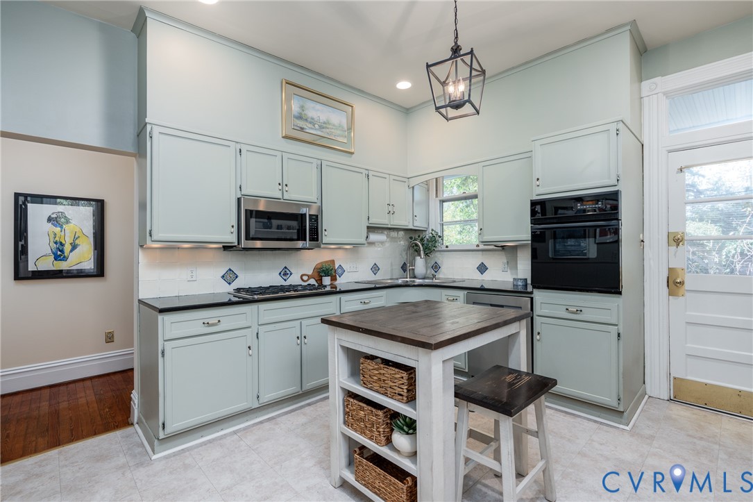 Eat-in kitchen with painted cabinetry, a gas cooktop and a wall oven.