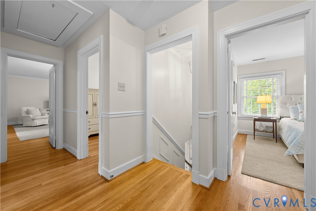 Hardwood flooring, crisp white trim, chair rail molding, and multiple interior entryways