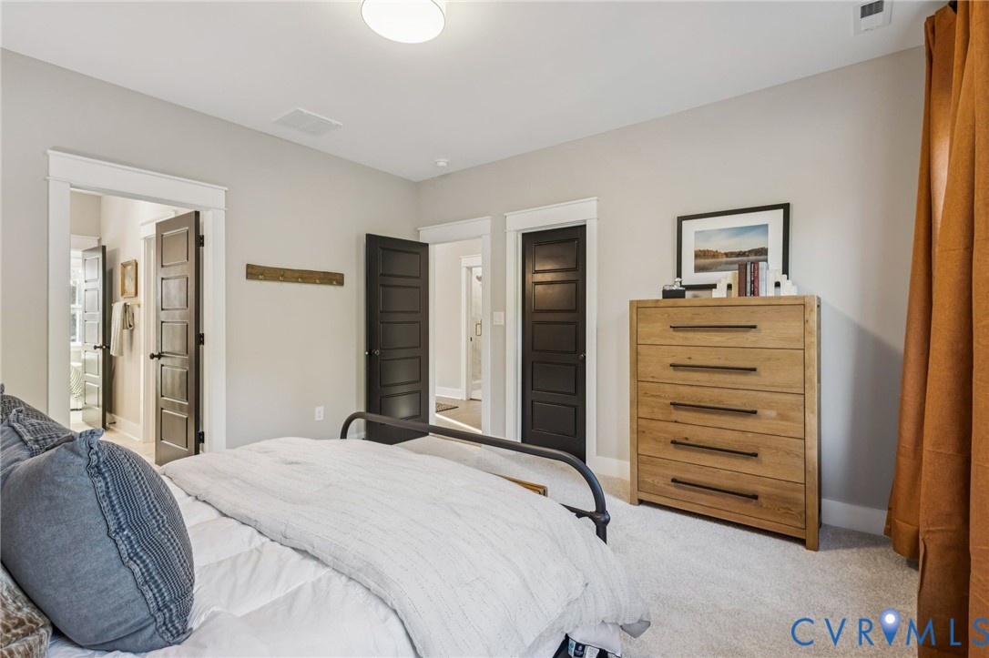 Interior room with light gray walls, white trim, and light gray carpet flooring