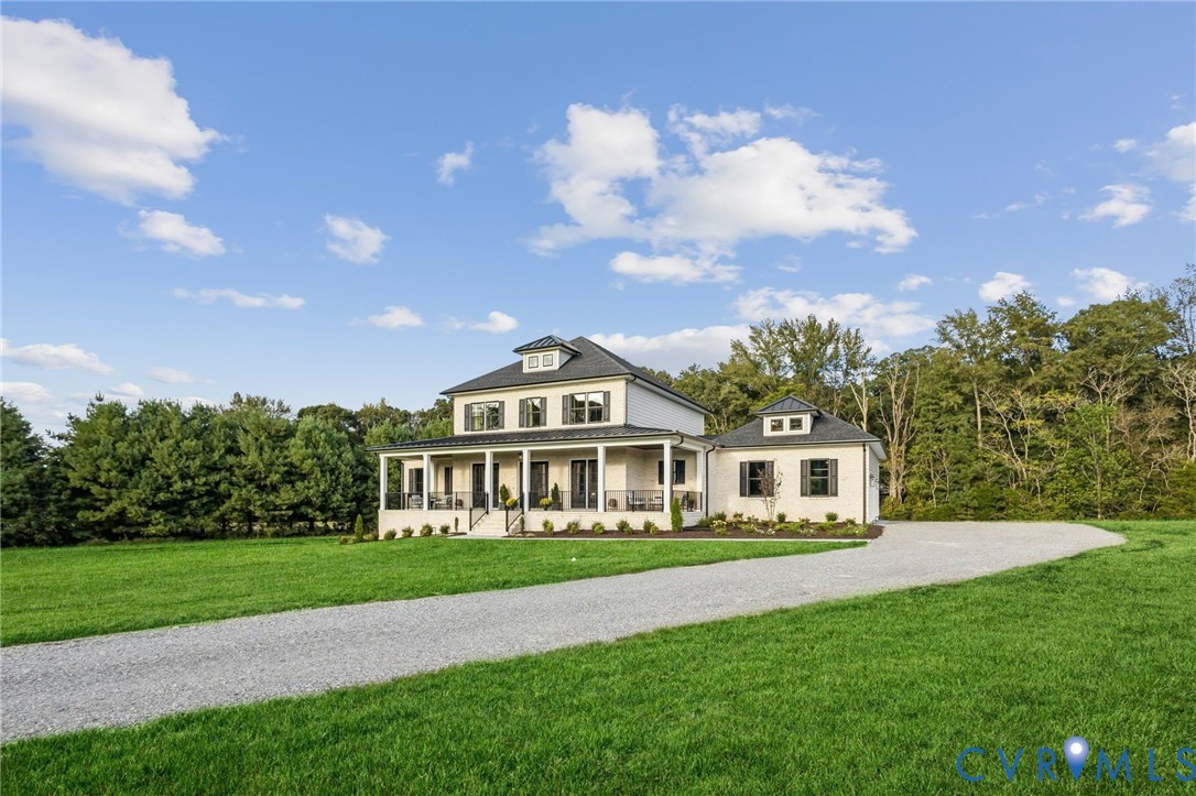 White exterior residence with a dark roof and multiple dormer windows