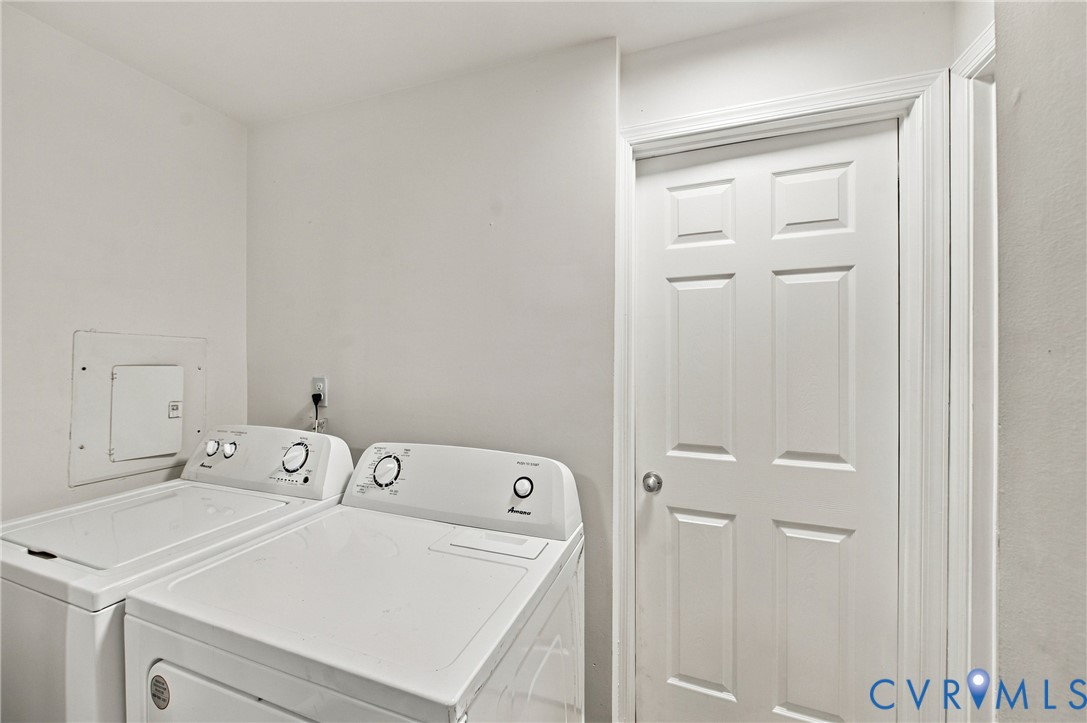Dedicated laundry space featuring white top-load appliances and a six-panel interior door