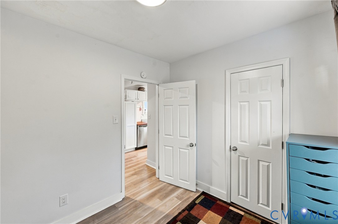 Neutral-toned interior featuring wood-finish flooring and six-panel doors
