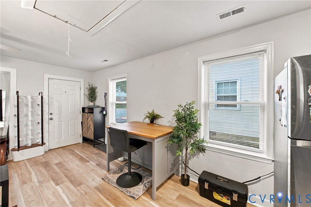 Wood-finish flooring, dual windows with blinds, and solid-panel interior door