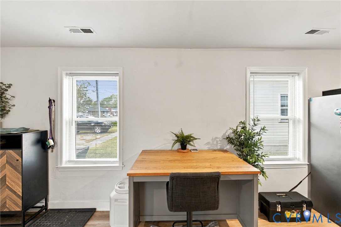 Interior space featuring dual pane windows and wood-finish flooring