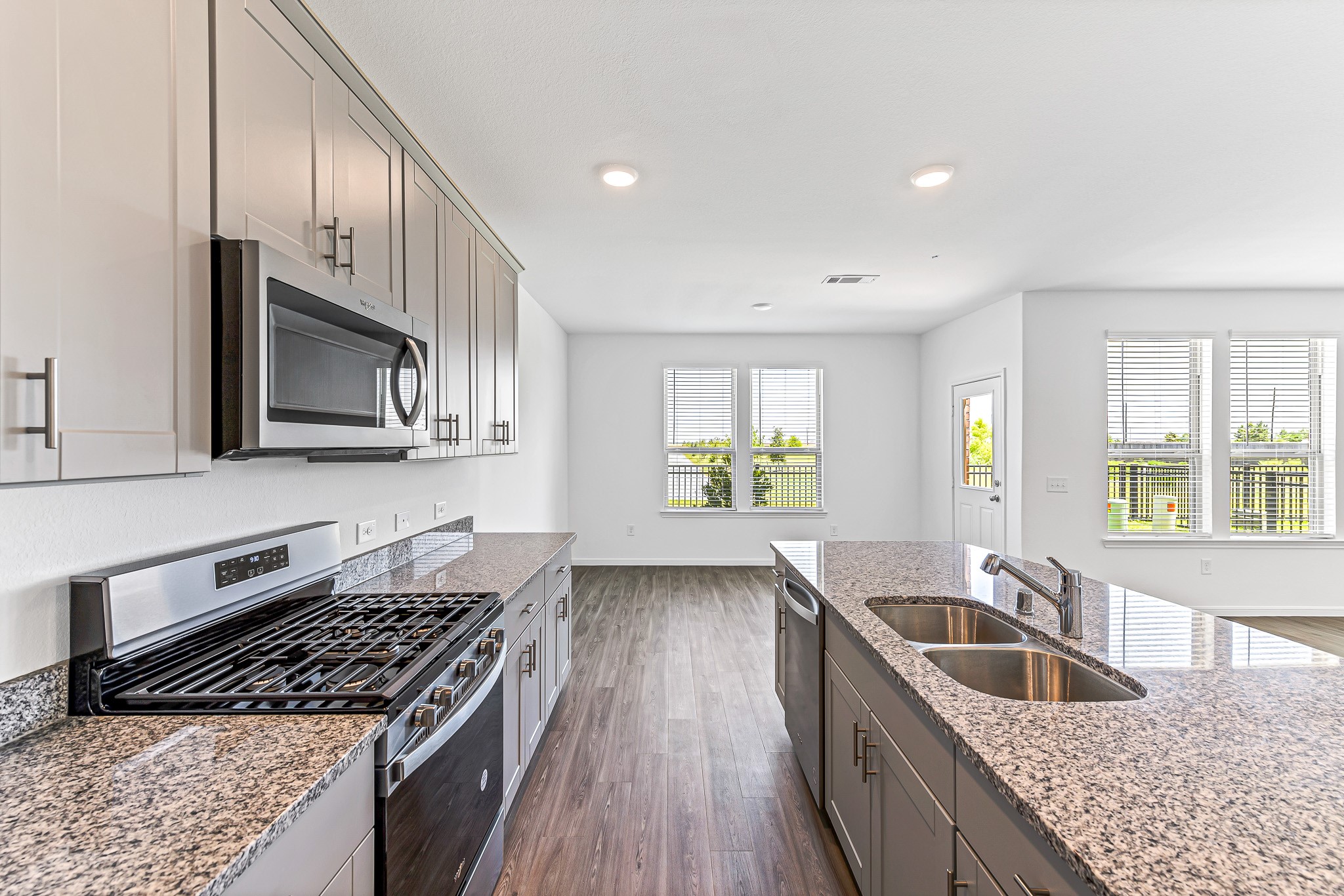 Beautiful modern kitchen with gray cabinets, island, stainless steel appliances and granite counters. Opens to the dining. Stunning lake view. Beautiful modern kitchen with gray cabinets, island, stainless steel appliances and granite counters. Opens to the dining. Stunning lake view.