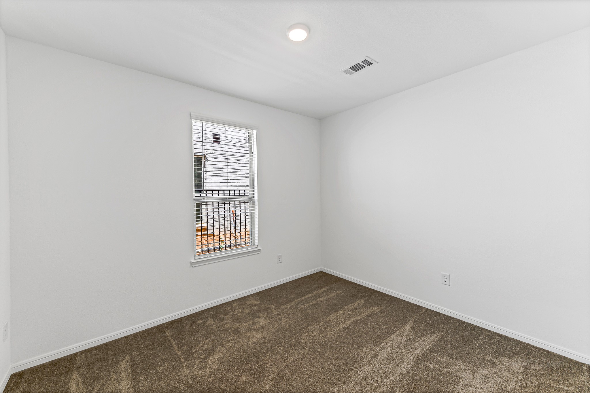 Versatile secondary bedroom at first floor, with direct access to full bathroom. Excellent as in-law suite, home office or guest room.
