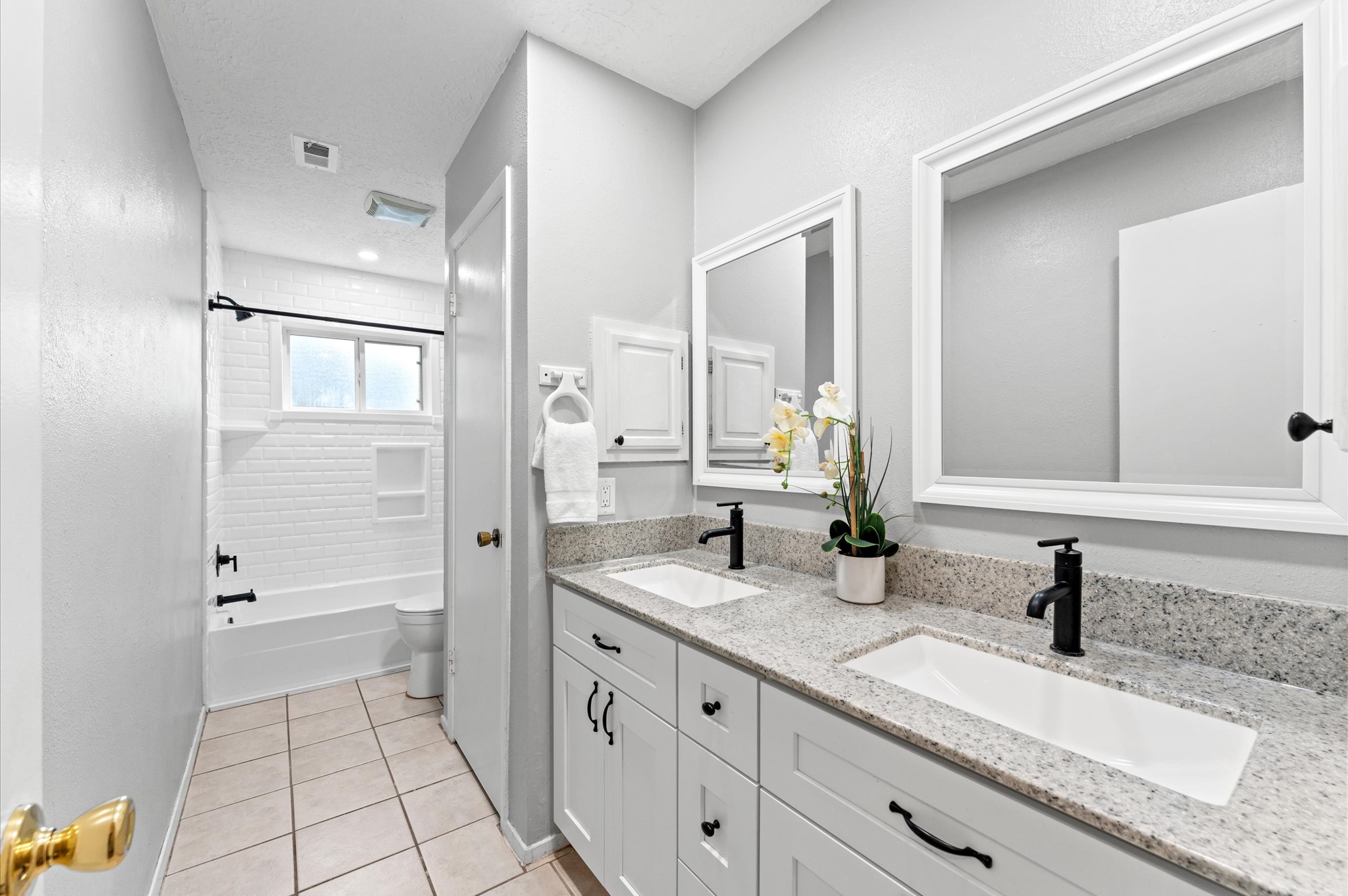 The hall bath was updated in 2023 to include granite counters, hardware, and framed mirrors.