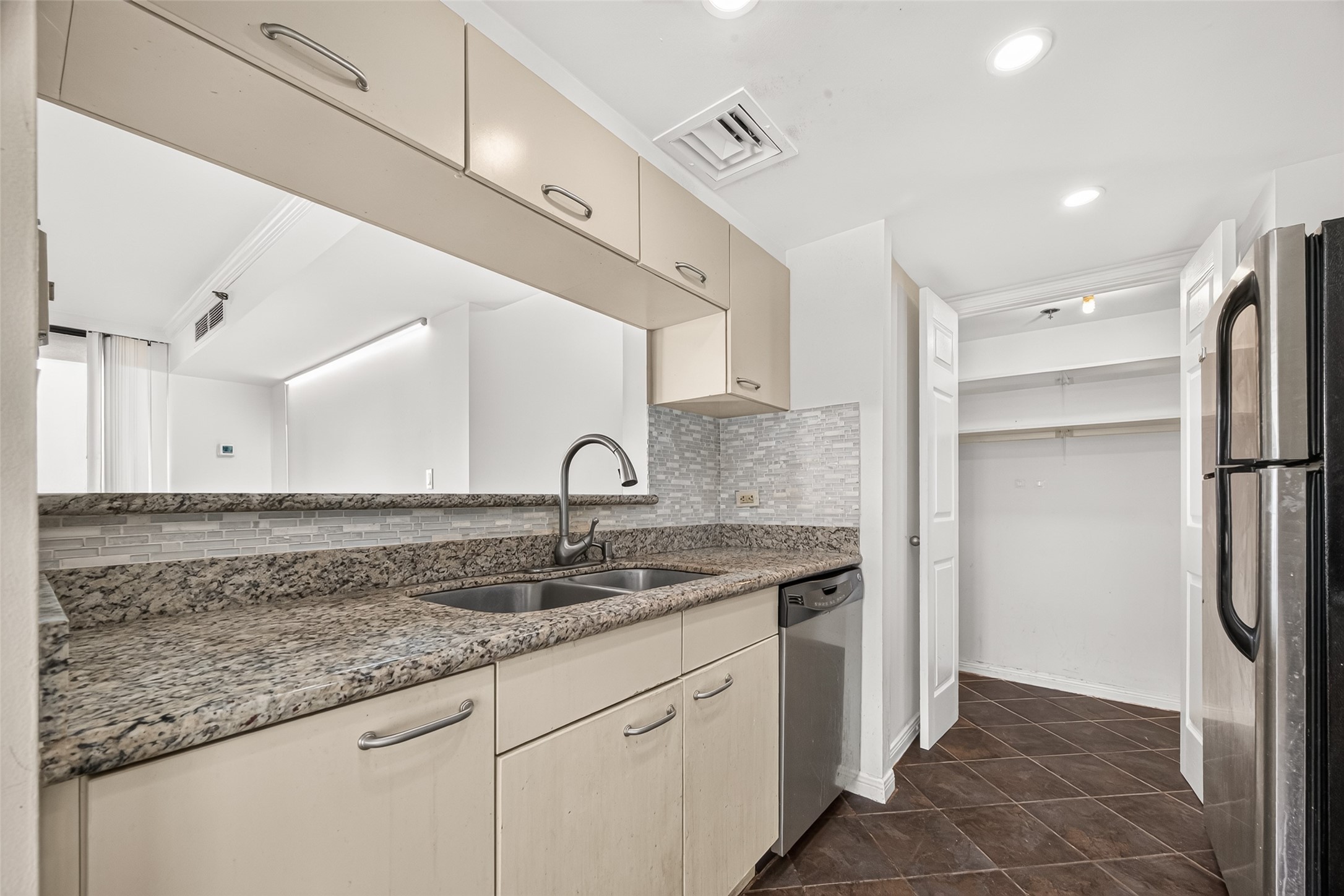 View of the kitchen opening up to the living room