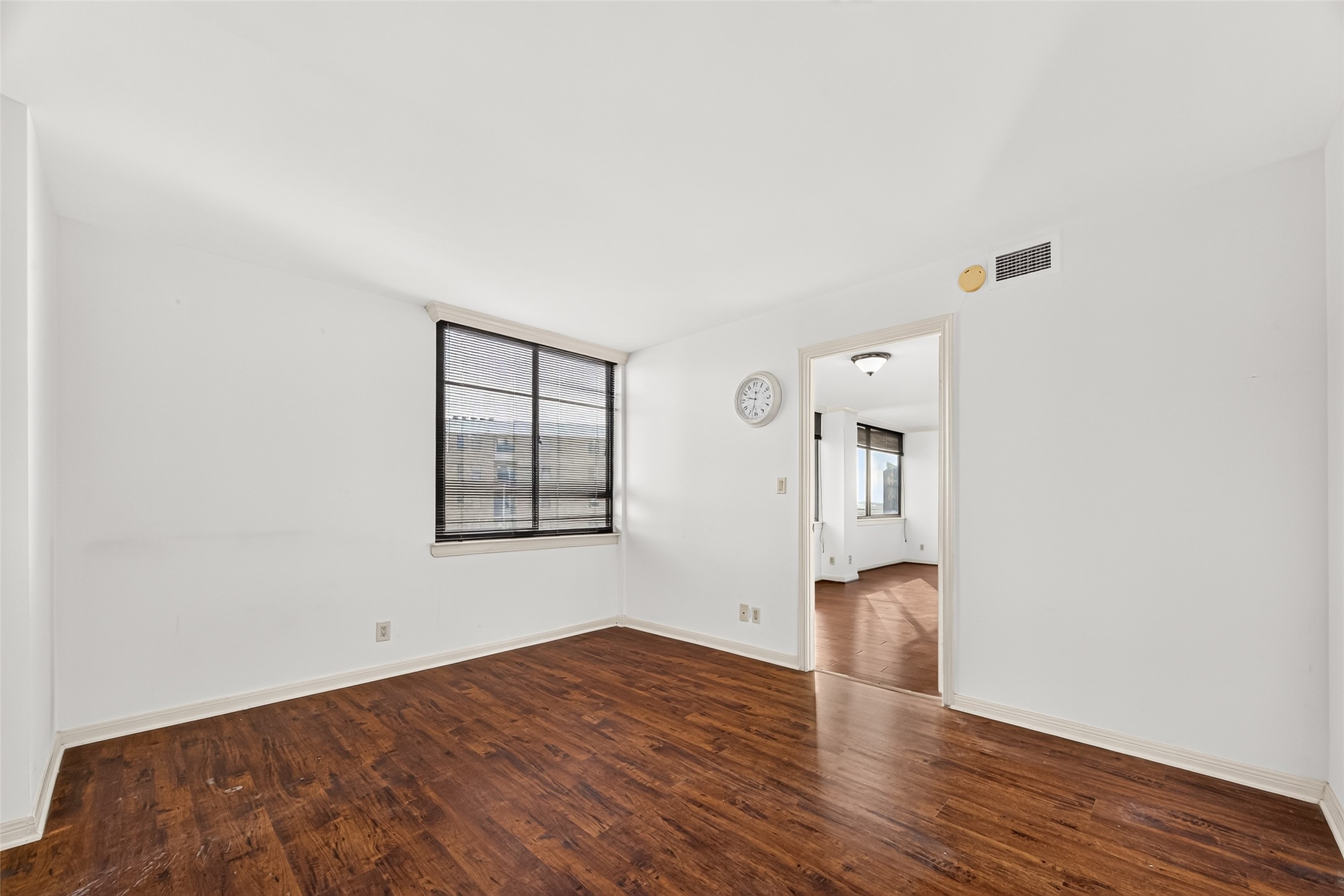 Primary bedroom located outside the dining area with views into the courtyard
