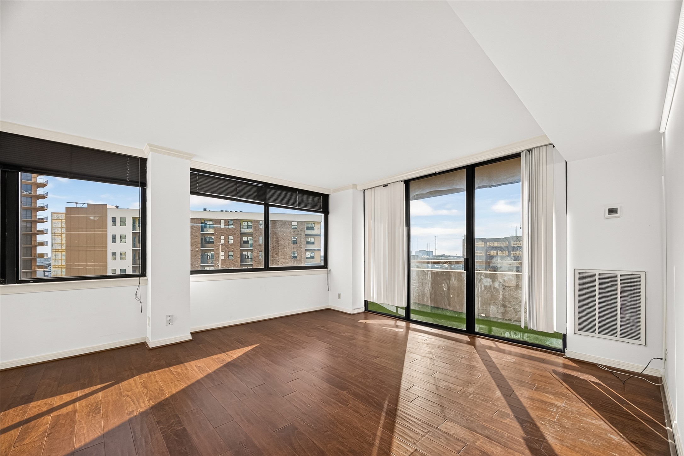 Spacious living room with engineered hardwood flooring, lots of natural light, beautiful views and your own private balcony!
