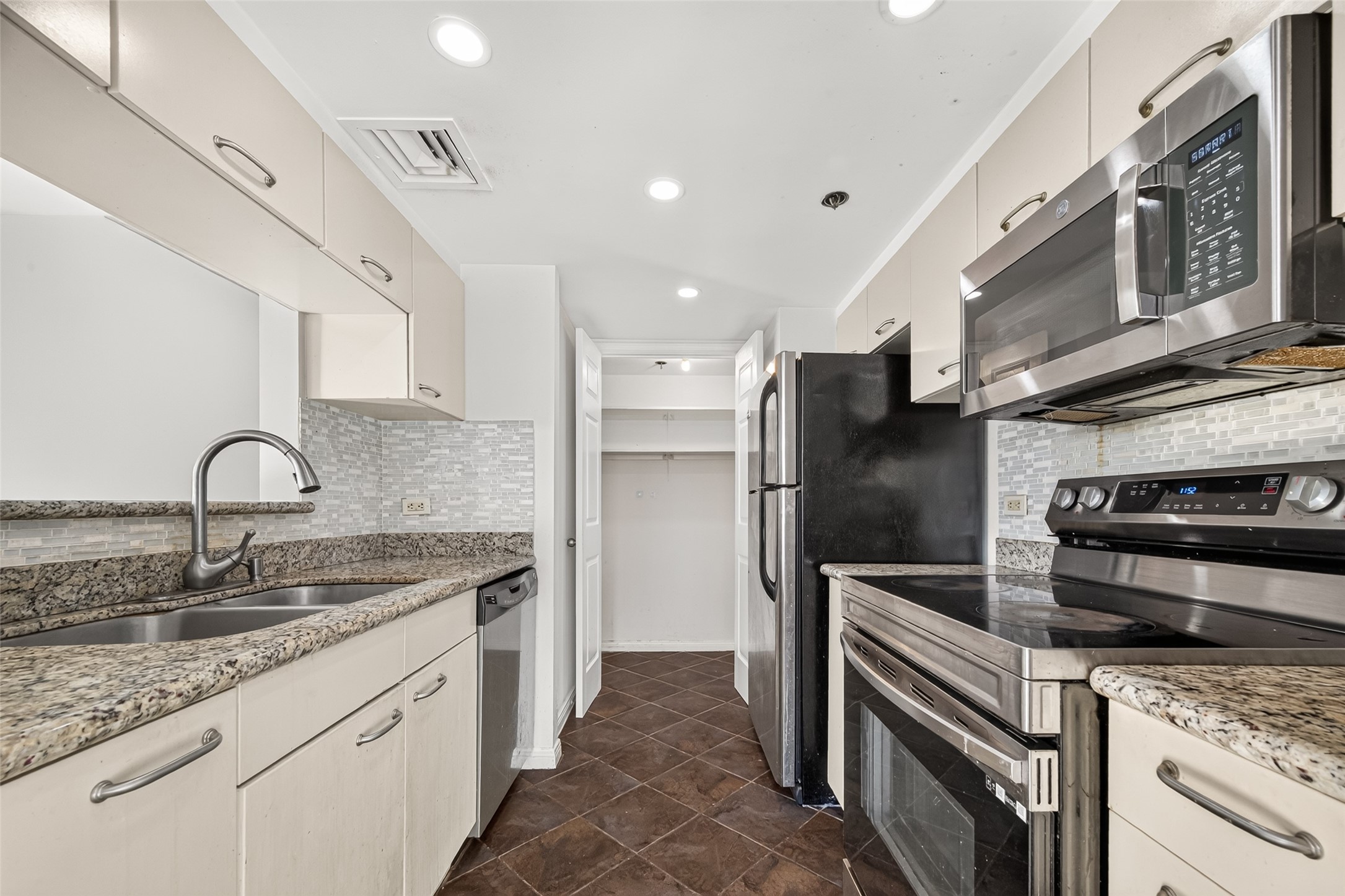 Kitchen opens up to living & dining room with stainless appliances, granite countertops and utility room. Refrigerator included