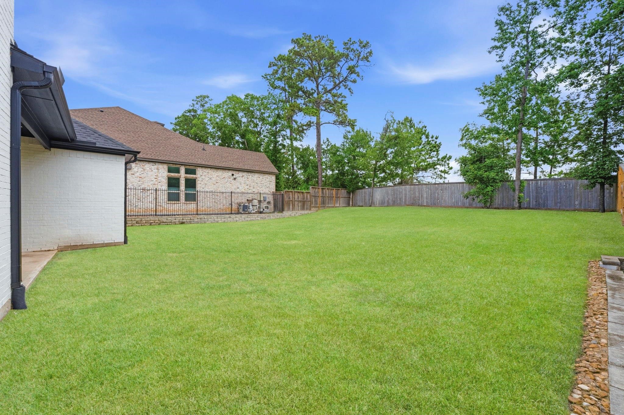 An expansive, fully fenced backyard
featuring a massive lush green lawn,
mature trees along the perimeter,
and plenty of space for outdoor living
or a future pool. This photo has been
digitally staged to illustrate the
possibilities of the homes aesthetic
and potential design. Some
furnishings and dcor shown are for
visual inspiration.