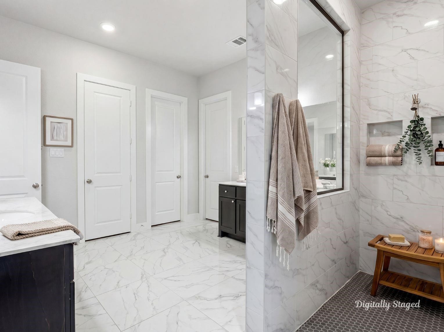 An alternative view of the primary
bathroom highlighting the expansive,
zero-threshold walk-in shower with
beautiful marble-patterned wall tile
and a sleek pebble tile floor. This
photo has been digitally staged to
illustrate the possibilities of the
homes aesthetic and potential
design. Some furnishings and dcor
shown are for visual inspiration.