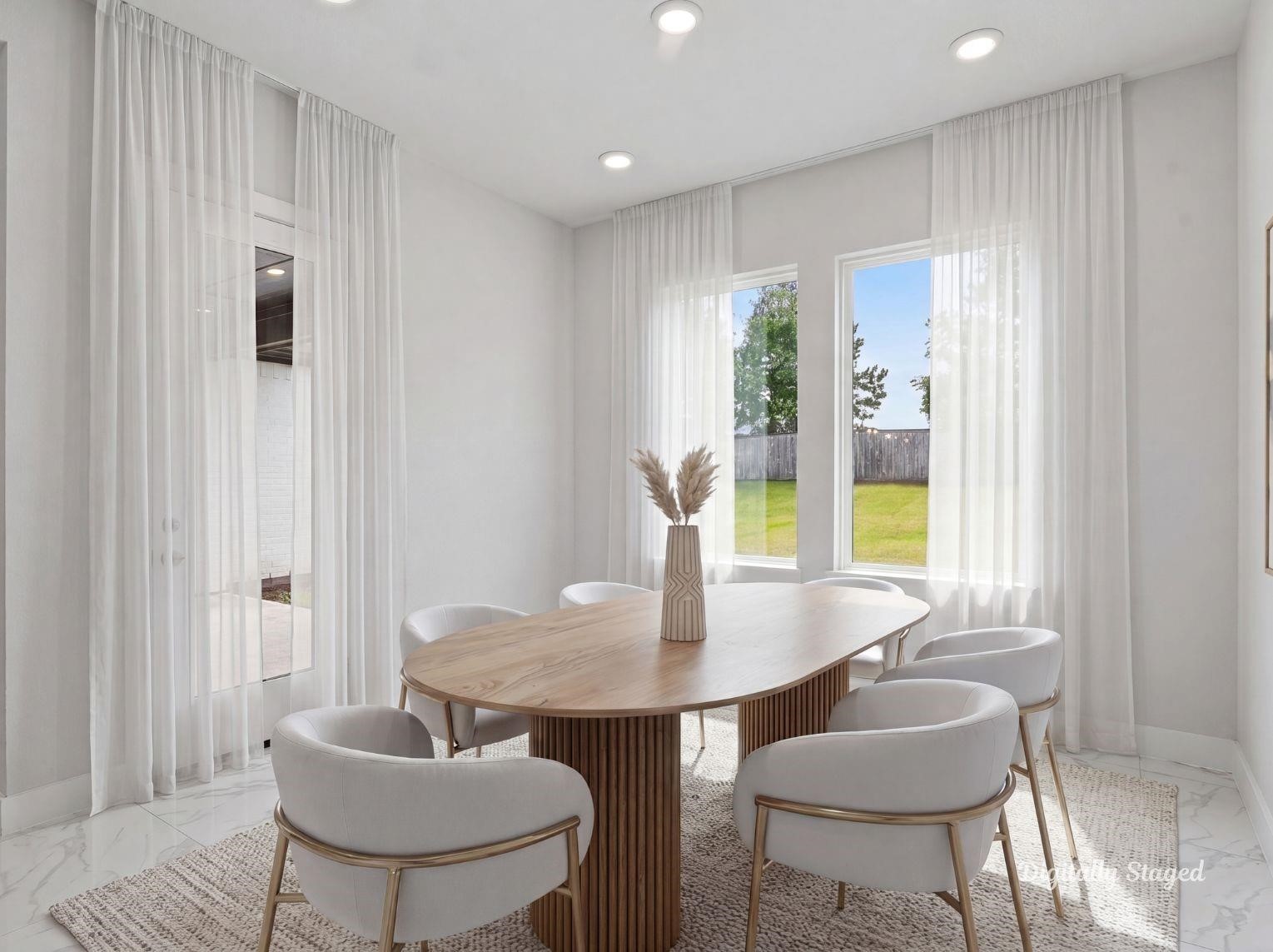 A dedicated formal dining space
surrounded by large windows and
polished tile flooring. This photo has
been digitally staged to illustrate the
possibilities of the homes aesthetic
and potential design. Some
furnishings and dcor shown are for
visual inspiration.