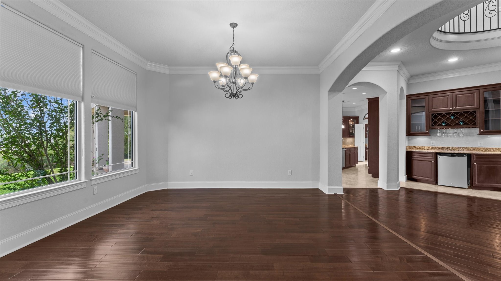 Dining room. To the right is a wine bar with a refrigerator. Straight ahead leads to the kitchen. Dining room. To the right is a wine bar with a refrigerator. Straight ahead leads to the kitchen.