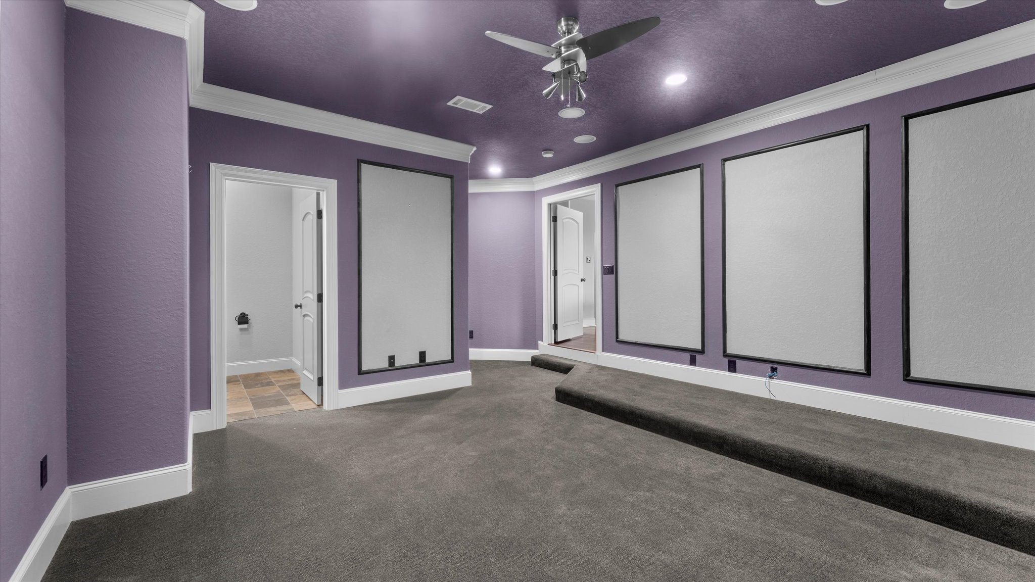Media room with a half bath attached.