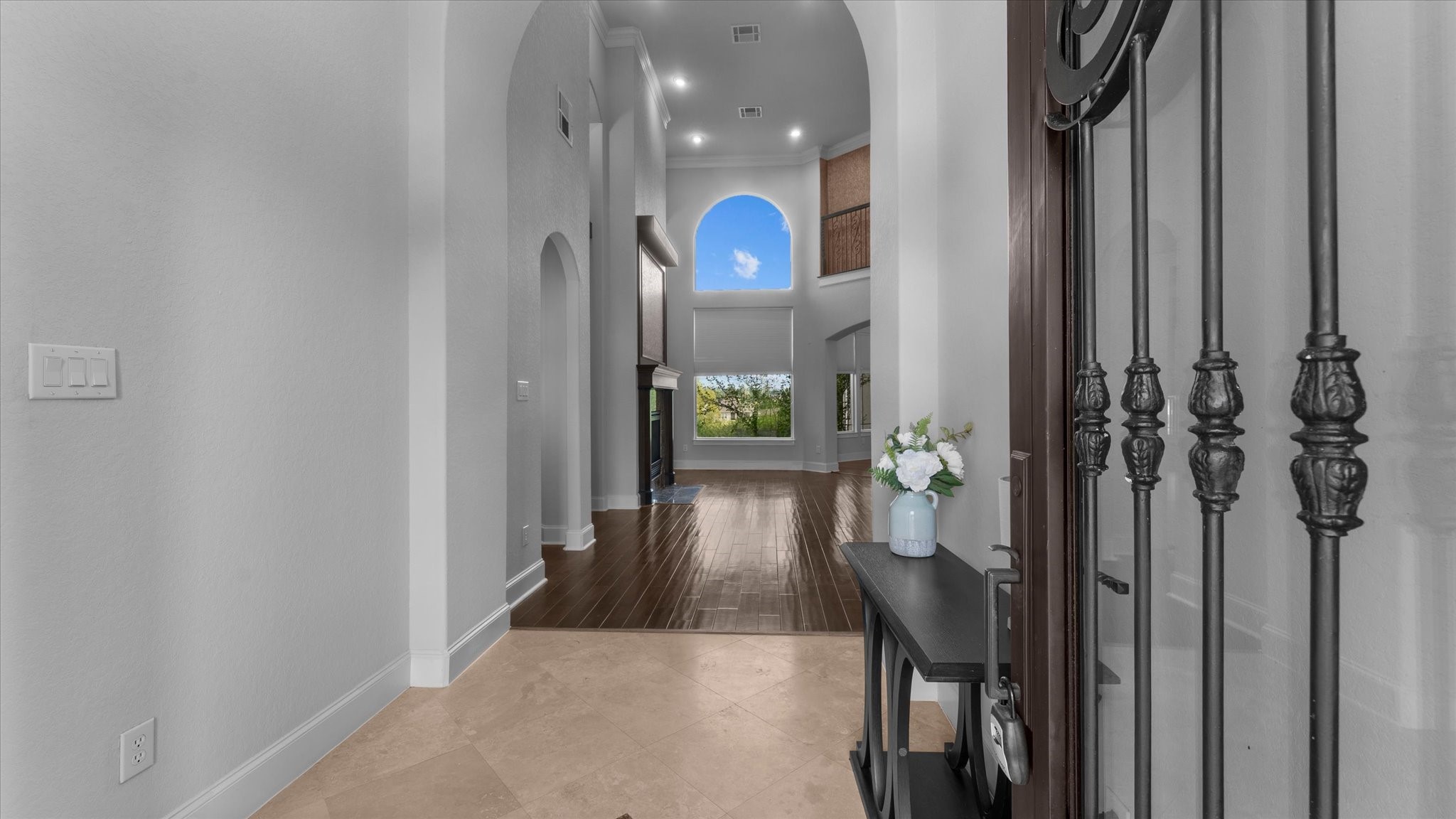 Entering the home through the travertine floored foyer, looking into the living room. Entering the home through the travertine floored foyer, looking into the living room.