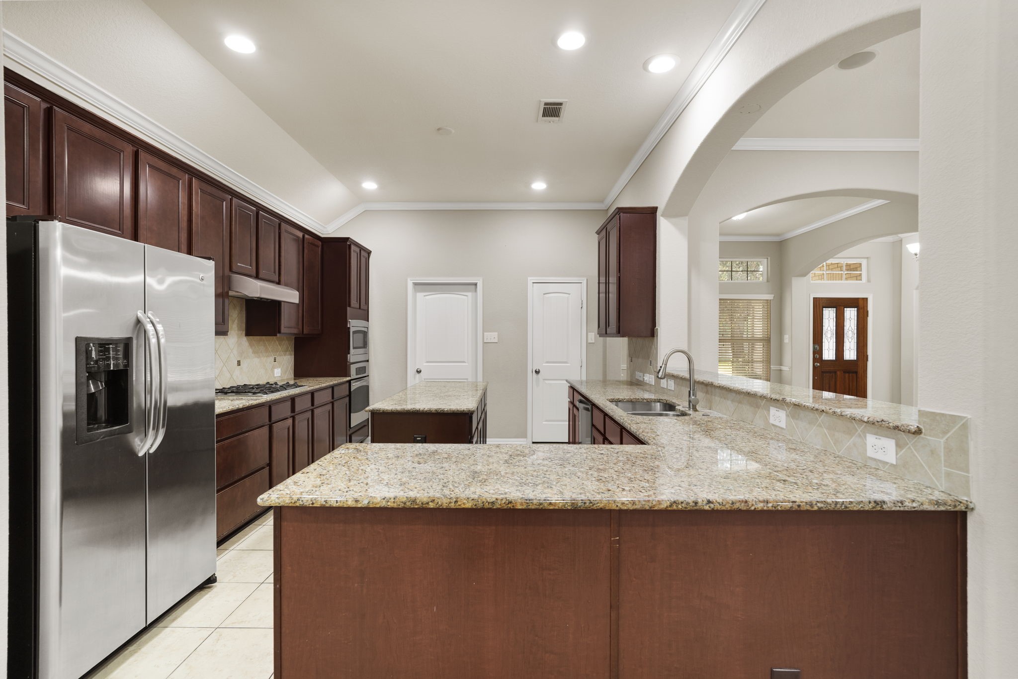 Convenient kitchen access to the laundry room, attached garage, and walk-in pantry makes daily routines and grocery storage a breeze.