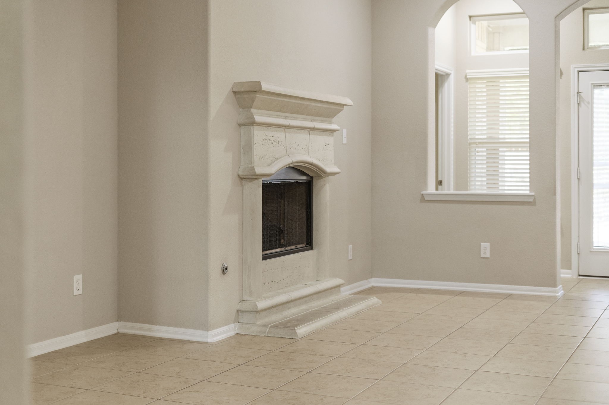 A cast stone fireplace serves as the focal point of the spacious family room.
