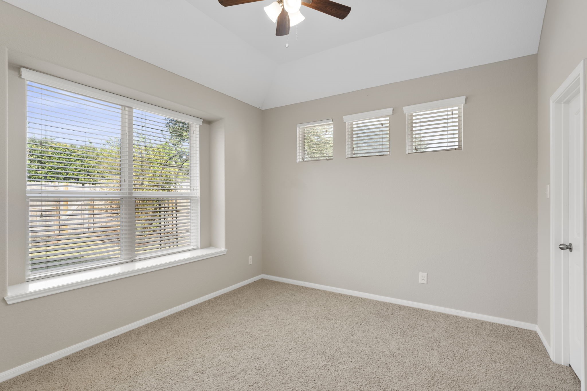 Privately tucked away at the back of the home, this delightful bedroom is filled with natural light from an expansive window featuring a deep sill and peaceful views of the backyard.