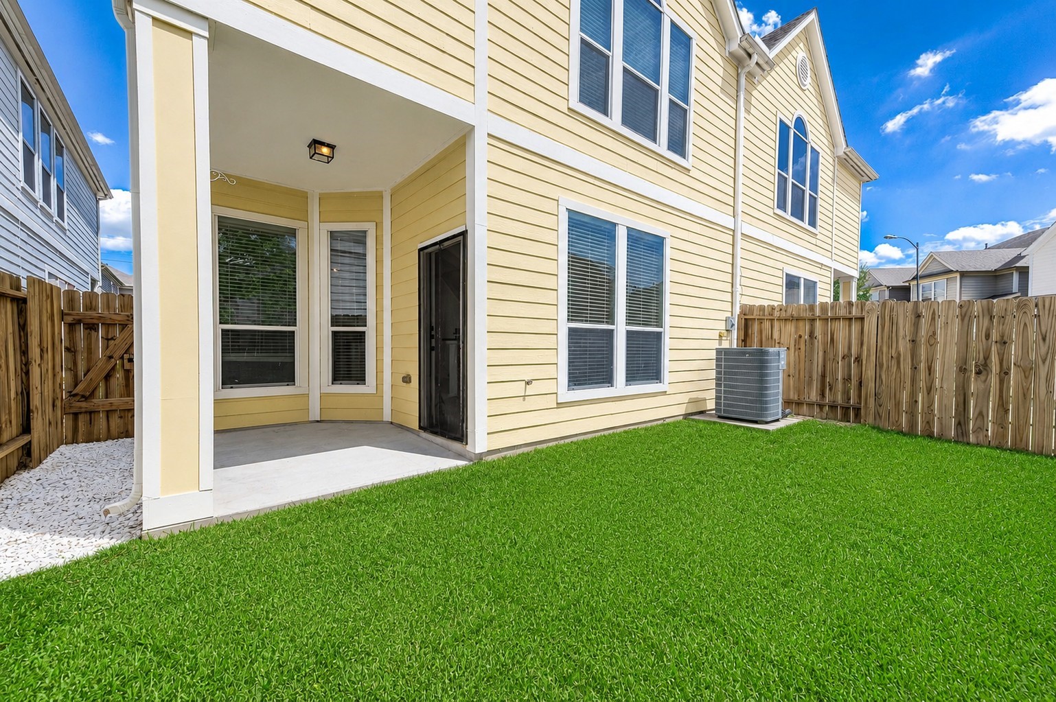 NOTE the side of the propety has a private entrance to the backyard.  Spacious Covered Patio is Perfect for enjoying the outdoor green space  and great for firing up the grill for family and guests meals ! Virtually staged to inspire design possibilities