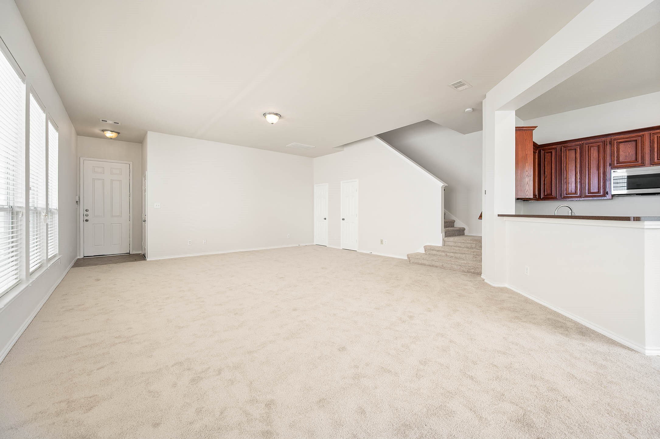 Spacious living/Family room has new carpeting fresh wall paint, large windows for natural light, includes a powder romm/half bath. Front door entryway seamlessly flows to Kitchen/dining and the breakfast bar allows additionsl dining seating. The staircase leads to the upper 2nd floor level. Spacious living/Family room has new carpeting fresh wall paint, large windows for natural light, includes a powder romm/half bath. Front door entryway seamlessly flows to Kitchen/dining and the breakfast bar allows additionsl dining seating. The staircase leads to the upper 2nd floor level.