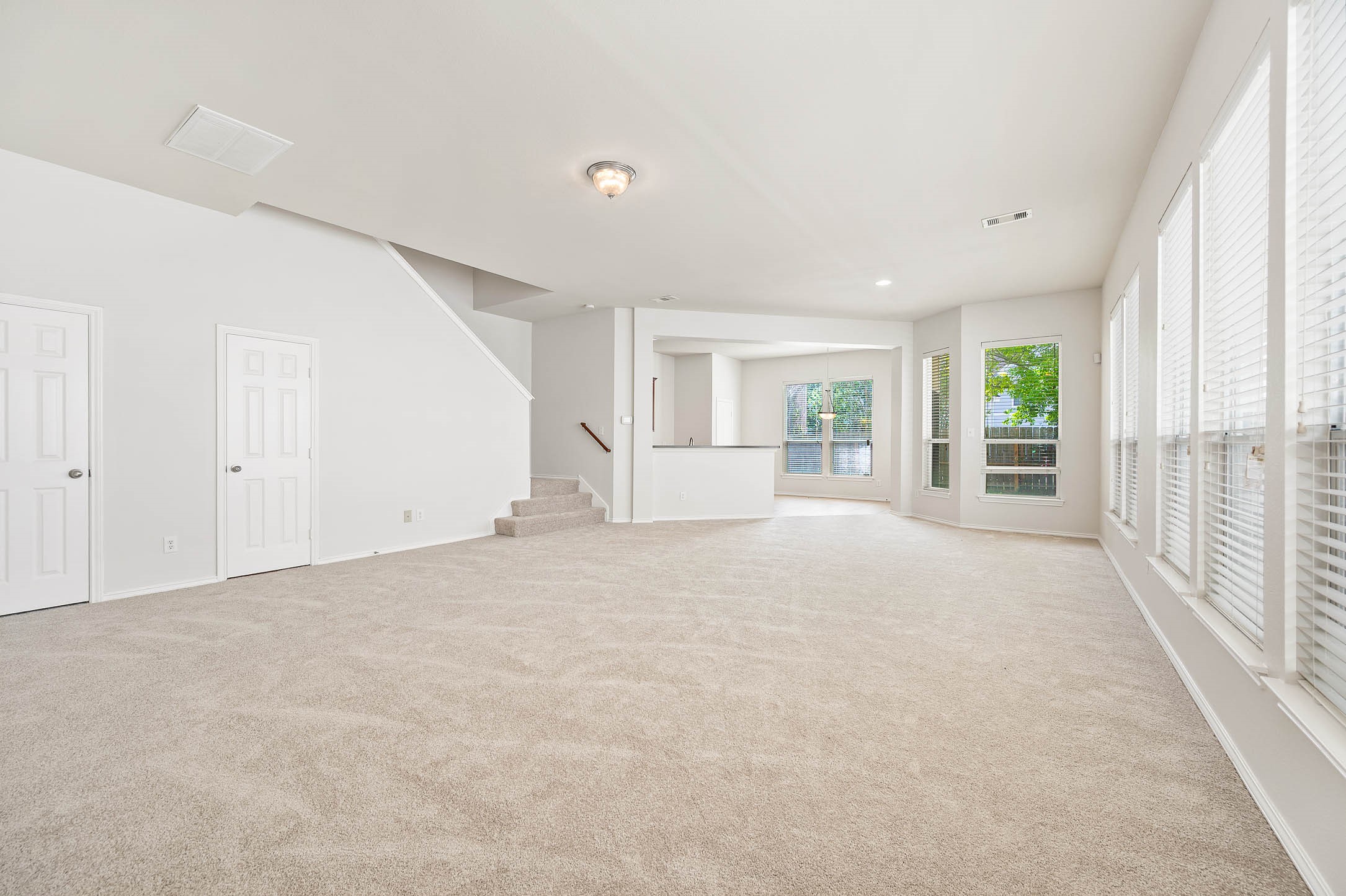 Living area. new carpet, fresh designer paint, large windows providing ample natural light, and an open layout leading to a cozy dining nook. Perfect for family gatherings and entertaining. Living area. new carpet, fresh designer paint, large windows providing ample natural light, and an open layout leading to a cozy dining nook. Perfect for family gatherings and entertaining.