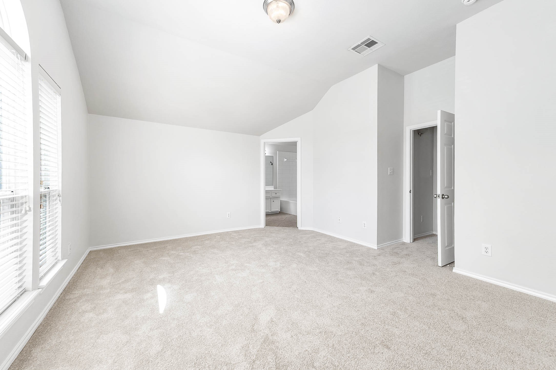 WOW ! Primary Bedroom is so roomy ! New carpet, soaring vaulted ceiling, and ample natural light enters with the large energy efficient windows. The en-suite bathroom has a LARGE SOAKING TUB ! Neutral painted walss and NEW carpet ideal for personalization.