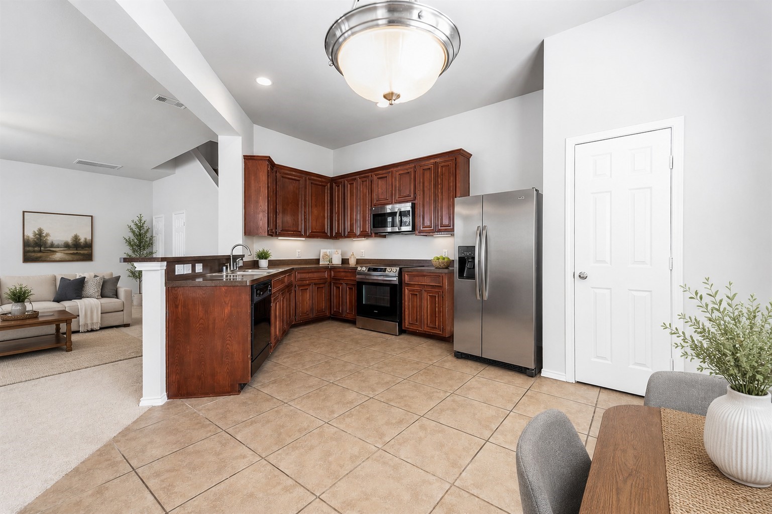 Enter the spacious kitchen/dining areas and note rich wooden cabinets, stainless steel appliances, and a designer tile flooring. This area allows an open floor plan that includes a spacious adjacent living/family room Note Illuminating designer ceiling light fixtures! Virtually staged to inspire design possibilities