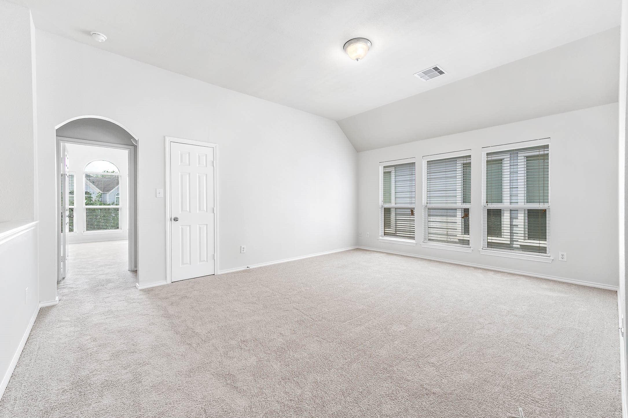 Upper Level LOFT -Use for Gameroom etc /Designer arched doorway leads into a large bonus room with closet, new carpet and fresh paint...Lots of energy efficient windows!
