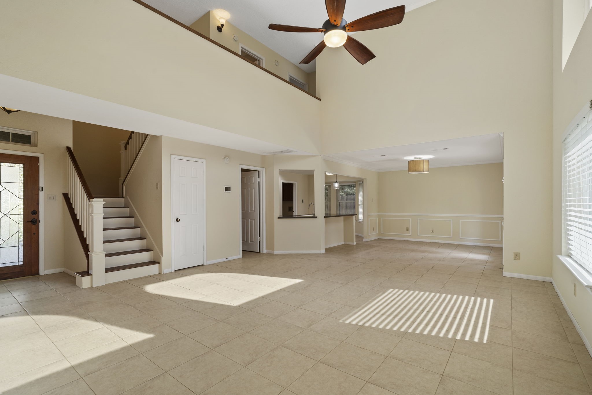 A spacious, light-filled living area features a dramatic two-story ceiling & an open layout that flows easily into the dining area & kitchen. A spacious, light-filled living area features a dramatic two-story ceiling & an open layout that flows easily into the dining area & kitchen.