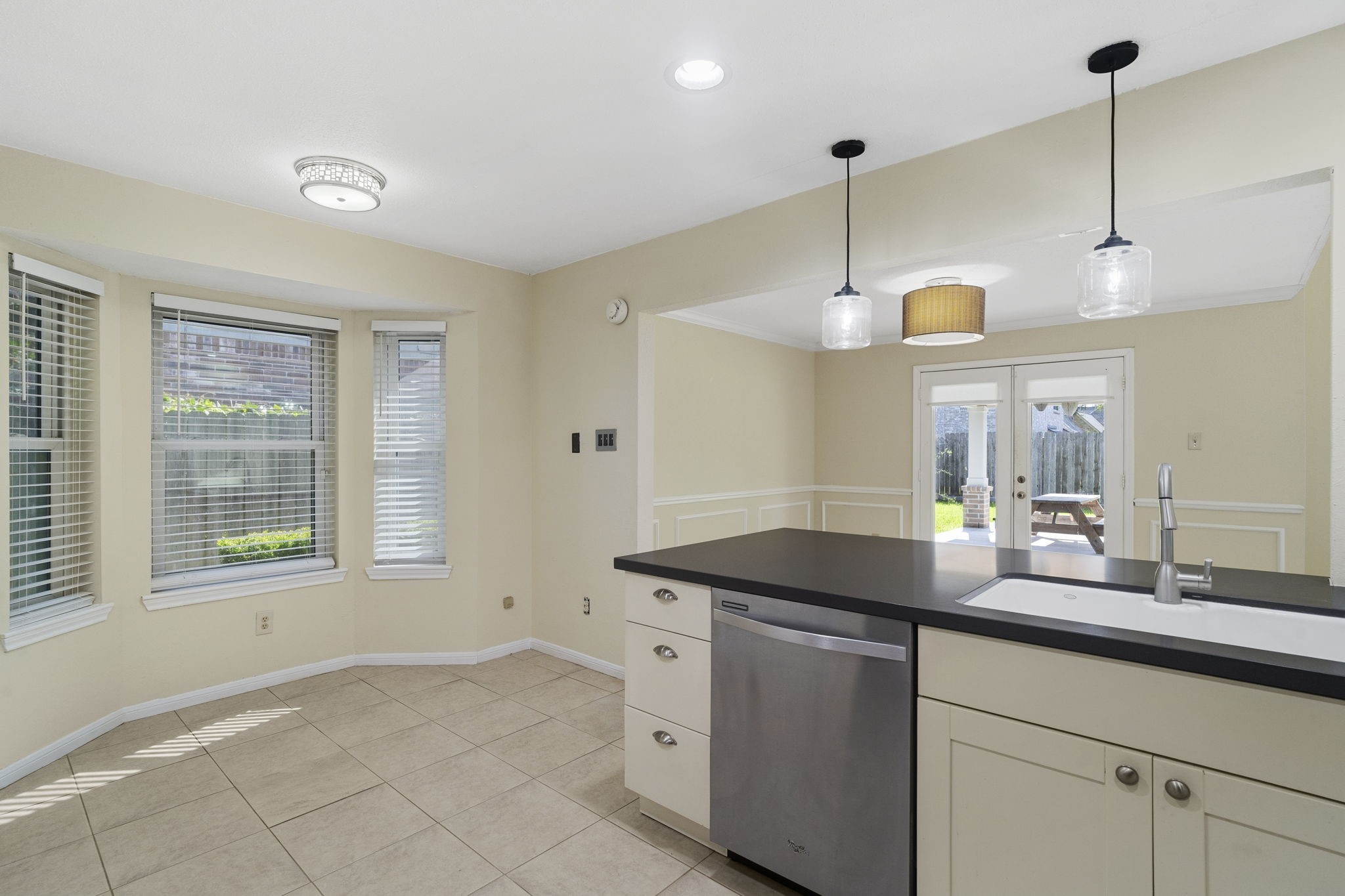 A bright breakfast area surrounded by windows provides the perfect spot for casual dining.