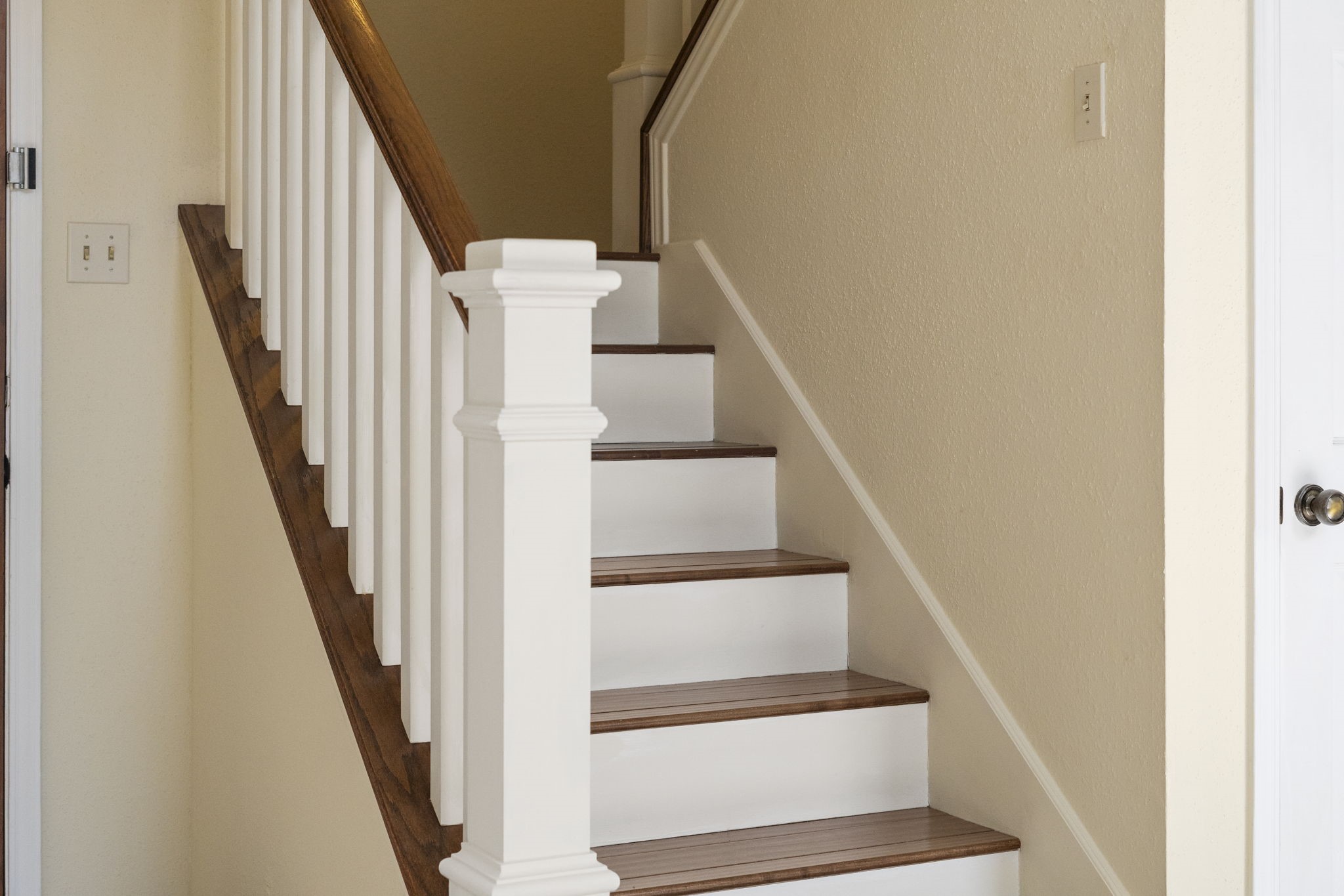 Beautiful wood stair treads & handrails create a warm contrast against crisp white trim.