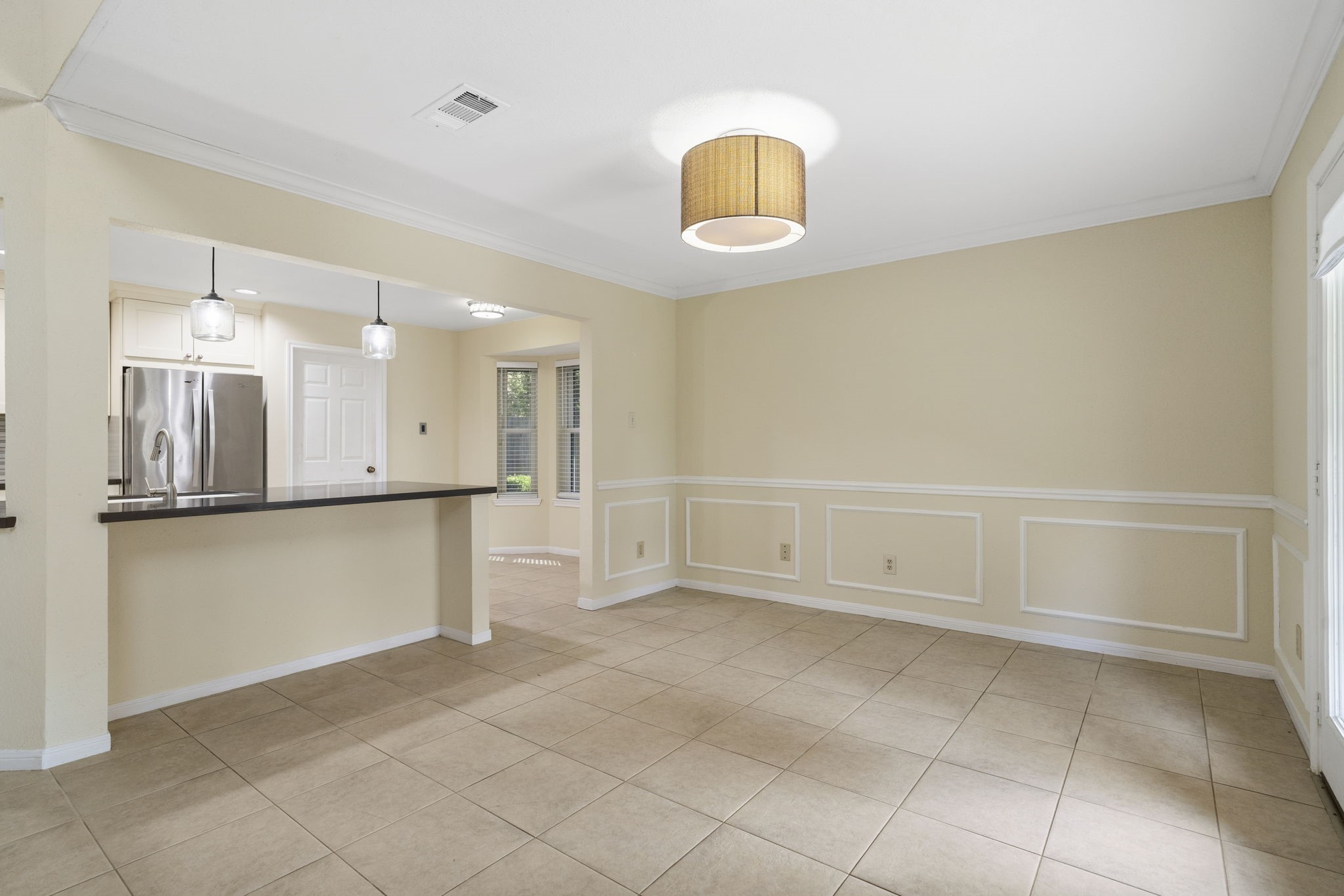 The dining room offers plenty of space for everyday meals or larger gatherings, with classic molding details & an open connection to the kitchen for easy flow.