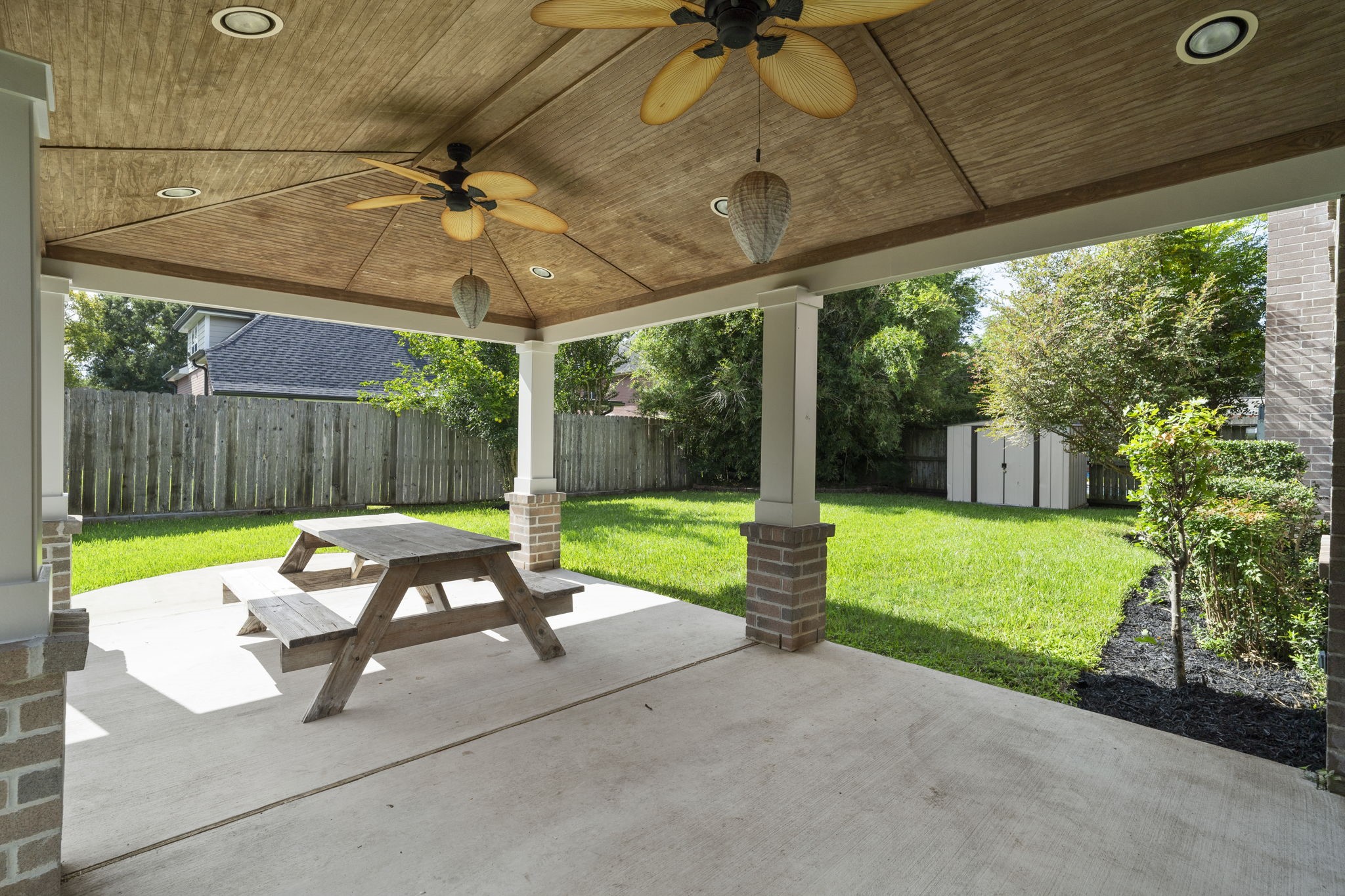 A spacious covered patio extends the living space outdoors, overlooking the private backyard.